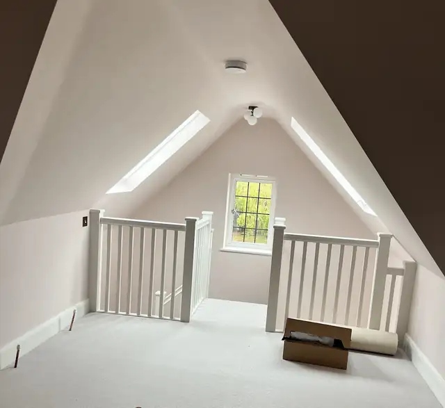 Loft room with skylights and white balustrade